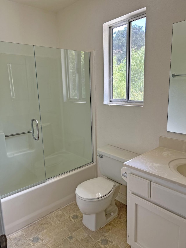 full bathroom with shower / bath combination with glass door, vanity, and toilet