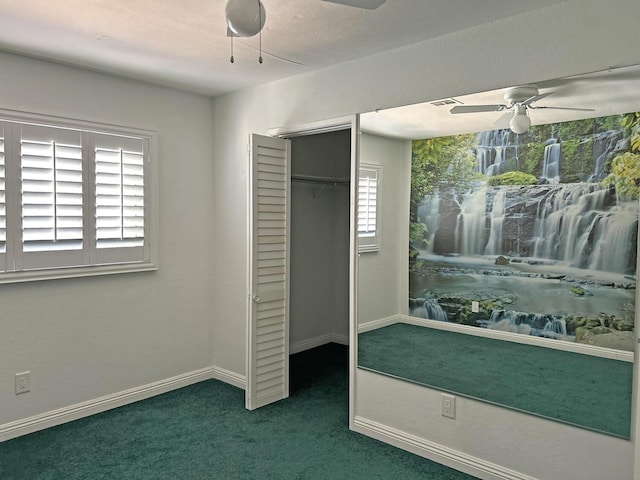 unfurnished bedroom with ceiling fan, a closet, and dark colored carpet