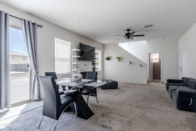 2022 Howard St, Rosamond, CA 93560 - carpeted dining area featuring a ceiling fan and a glass covered fireplace