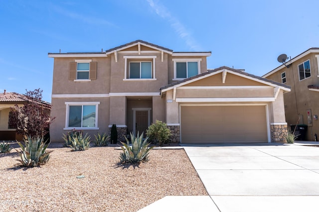 2022 Howard St, Rosamond, CA 93560 - view of front facade with stone siding, stucco siding, concrete driveway, and a garage