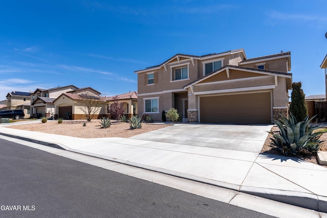 2022 Howard St, Rosamond, CA 93560 - view of front of home featuring stucco siding, stone siding, an attached garage, and driveway
