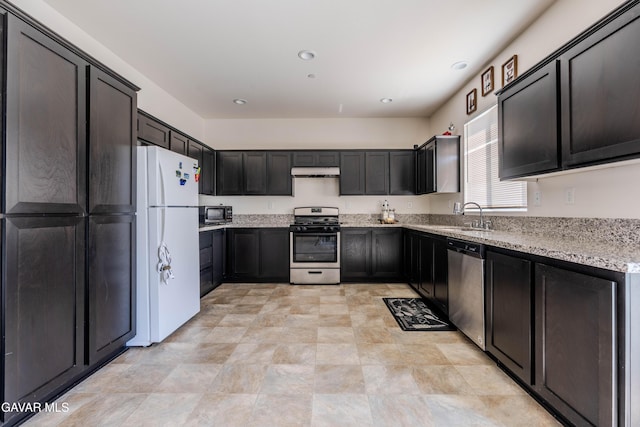 2022 Howard St, Rosamond, CA 93560 - kitchen featuring stainless steel appliances, under cabinet range hood, light stone countertops, and recessed lighting