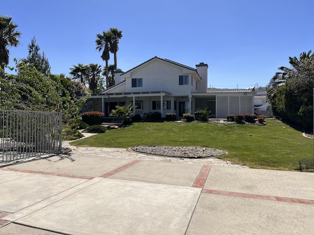 exterior space with a front yard, fence, stucco siding, and a chimney