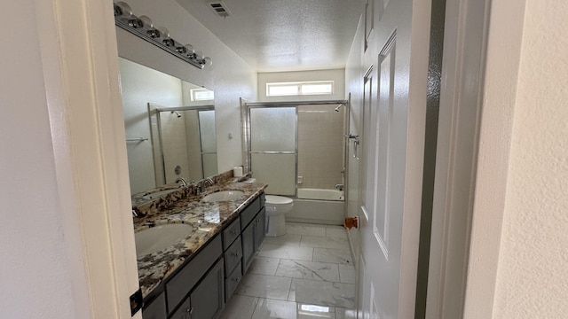 full bath with visible vents, toilet, marble finish floor, a sink, and double vanity