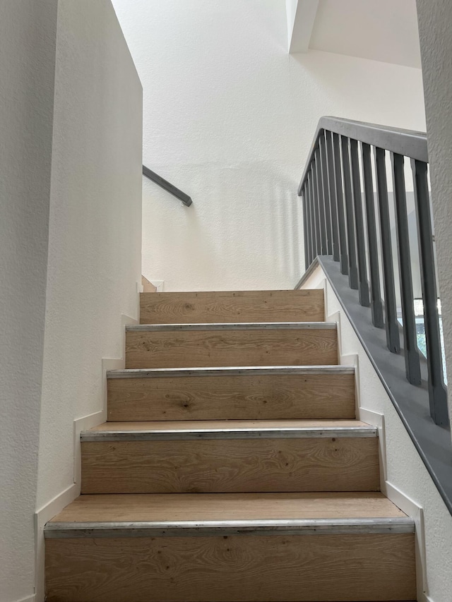 staircase with a textured wall
