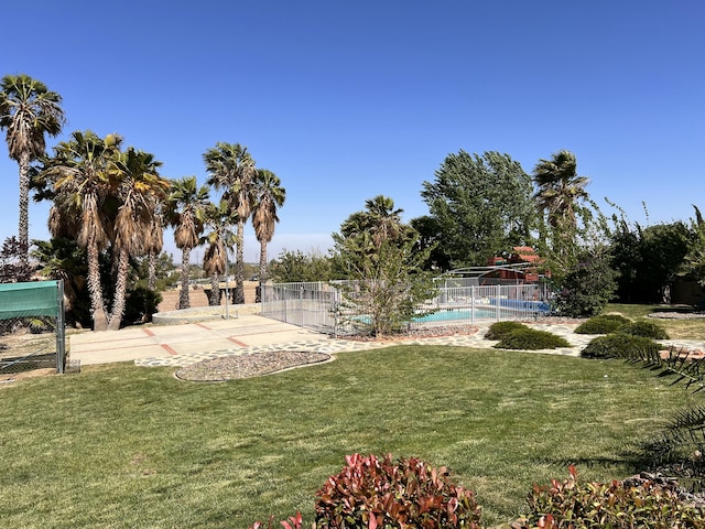 view of yard with fence and a fenced in pool
