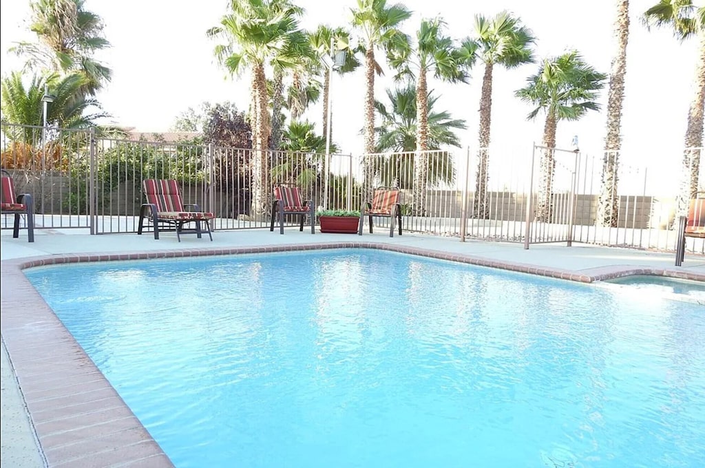 view of swimming pool with a fenced in pool, a patio area, and fence