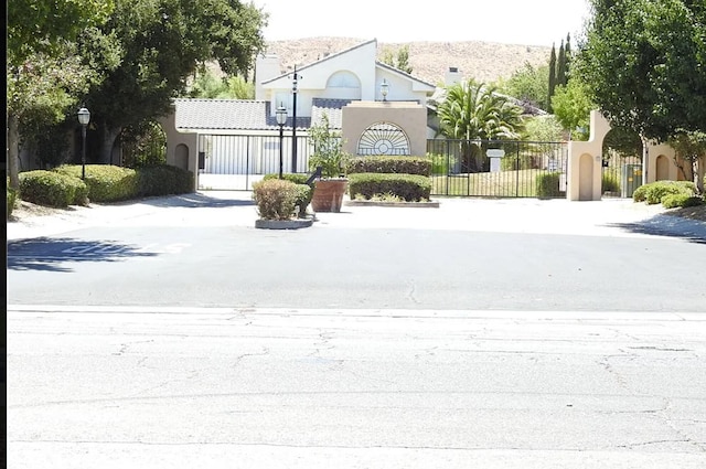 view of street with street lighting and a gate
