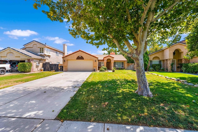 view of front of property with a garage and a front lawn