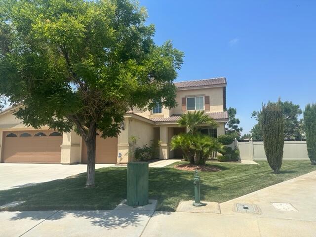 mediterranean / spanish-style house with a front yard and a garage