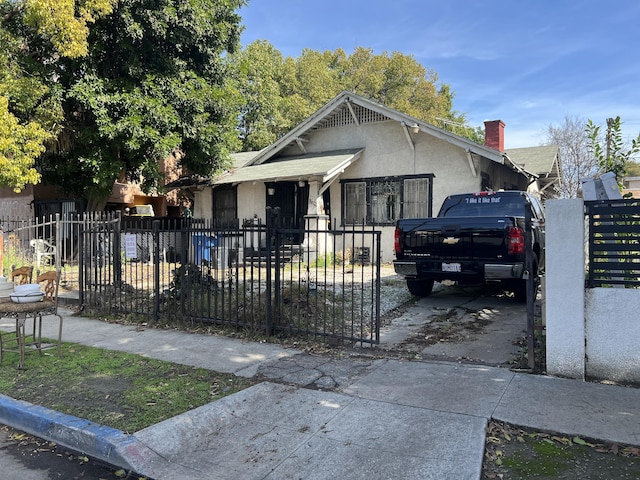 view of front of house featuring fence and stucco siding