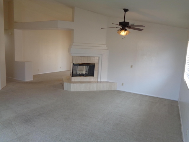 unfurnished living room with a ceiling fan, high vaulted ceiling, a fireplace, and carpet flooring