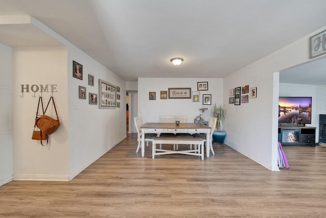 dining room with light wood-type flooring and baseboards