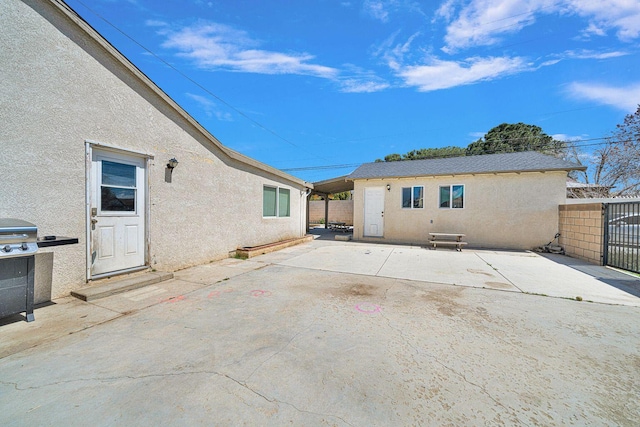 back of property featuring a patio, fence, and stucco siding