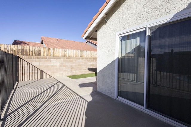 view of patio featuring fence