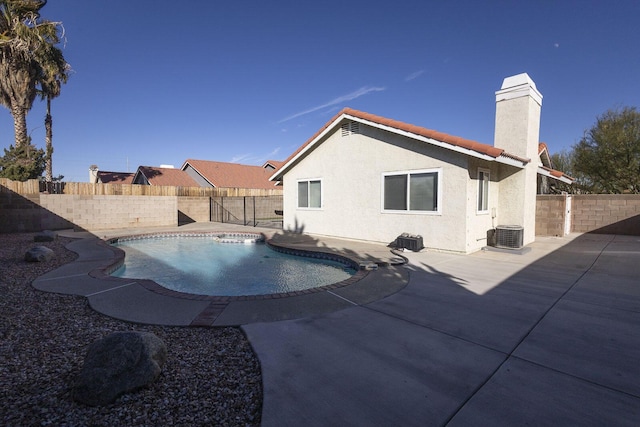 view of swimming pool featuring a fenced in pool, a fenced backyard, a patio, and central AC unit