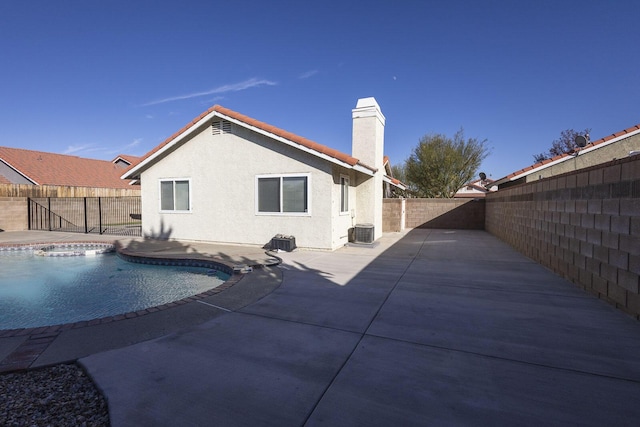 view of swimming pool featuring central AC unit, a patio area, a fenced backyard, and a fenced in pool