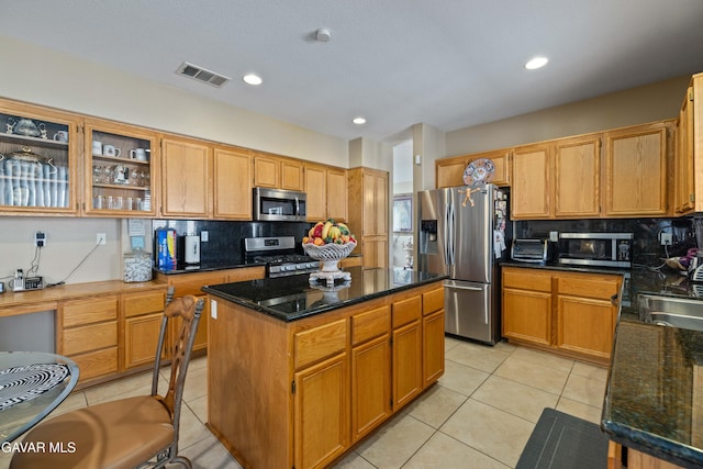 39243 Nicole Dr, Palmdale, CA 93551 - kitchen featuring stainless steel appliances, light tile patterned floors, decorative backsplash, a center island, and recessed lighting