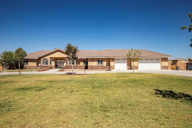 ranch-style house featuring a front yard and a garage