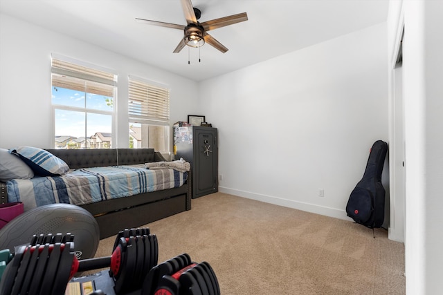 bedroom with light carpet, baseboards, and ceiling fan