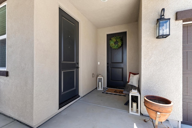 property entrance with stucco siding