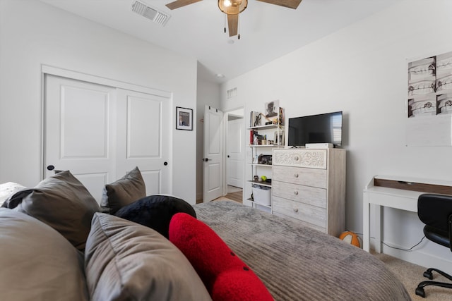 bedroom featuring a closet, a ceiling fan, and an office area
