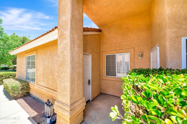 3524 San Jacinto Ave, Rosamond, CA 93560 - doorway to property with stucco siding and a tile roof