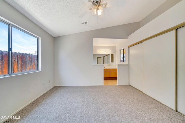 3524 San Jacinto Ave, Rosamond, CA 93560 - unfurnished bedroom with light colored carpet, a closet, ensuite bathroom, and a ceiling fan
