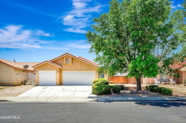 3524 San Jacinto Ave, Rosamond, CA 93560 - view of front of property with a garage, stucco siding, concrete driveway, and a tiled roof