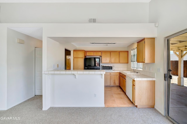 3524 San Jacinto Ave, Rosamond, CA 93560 - kitchen with fridge, tile counters, stainless steel microwave, a peninsula, and dishwasher
