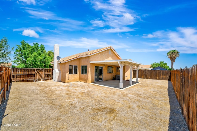 3524 San Jacinto Ave, Rosamond, CA 93560 - rear view of house with stucco siding, a patio area, a fenced backyard, and a tile roof