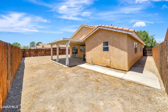 3524 San Jacinto Ave, Rosamond, CA 93560 - rear view of house with stucco siding, a patio, a fenced backyard, and a tiled roof