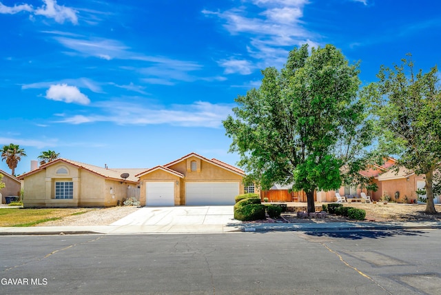 3524 San Jacinto Ave, Rosamond, CA 93560 - view of front of house with an attached garage, concrete driveway, and stucco siding