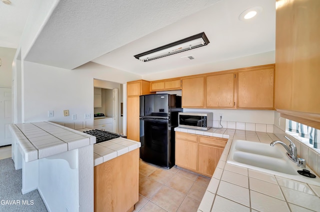 3524 San Jacinto Ave, Rosamond, CA 93560 - kitchen featuring freestanding refrigerator, tile counters, stainless steel microwave, light brown cabinets, and recessed lighting