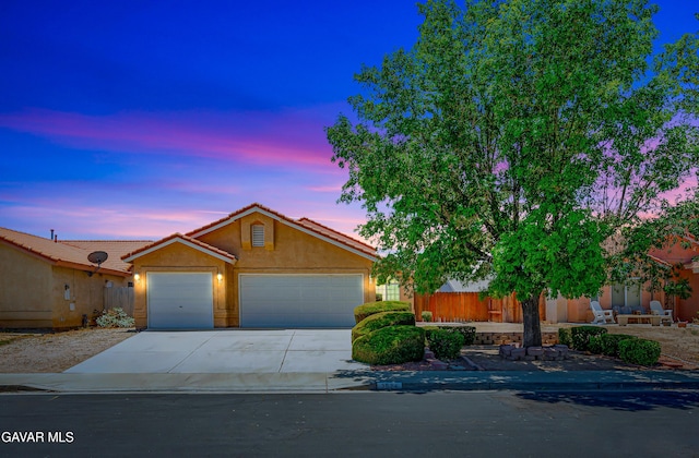 3524 San Jacinto Ave, Rosamond, CA 93560 - view of front of property featuring an attached garage, concrete driveway, stucco siding, and a tile roof