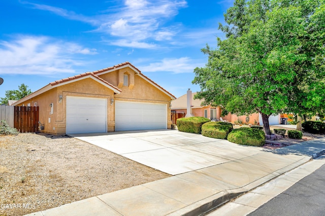 3524 San Jacinto Ave, Rosamond, CA 93560 - view of front of home featuring stucco siding, concrete driveway, a garage, and a tiled roof
