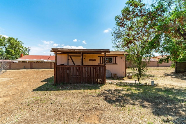 rear view of property with a fenced backyard