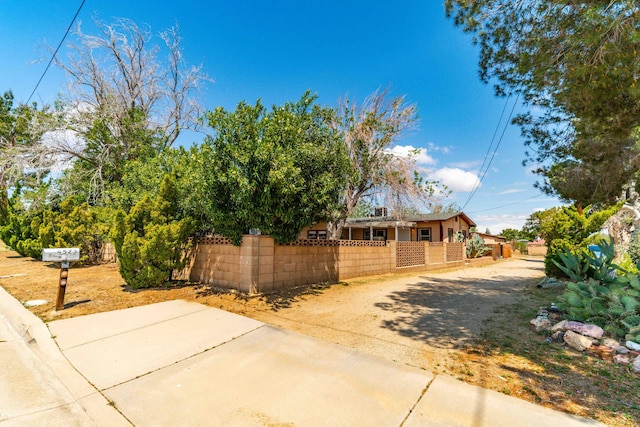 view of home's exterior featuring driveway and a fenced front yard