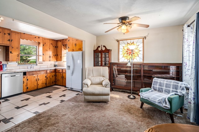 sitting room with a ceiling fan and light tile patterned floors