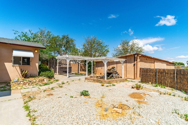 back of house with a pergola, fence, stucco siding, and a patio area