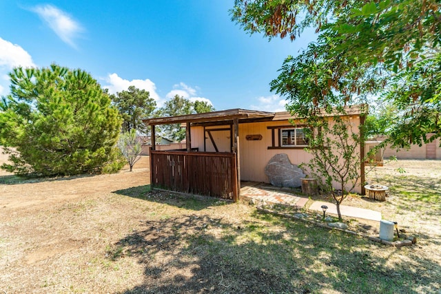 rear view of property with an outdoor structure