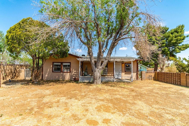 view of front of home featuring fence private yard and a gate