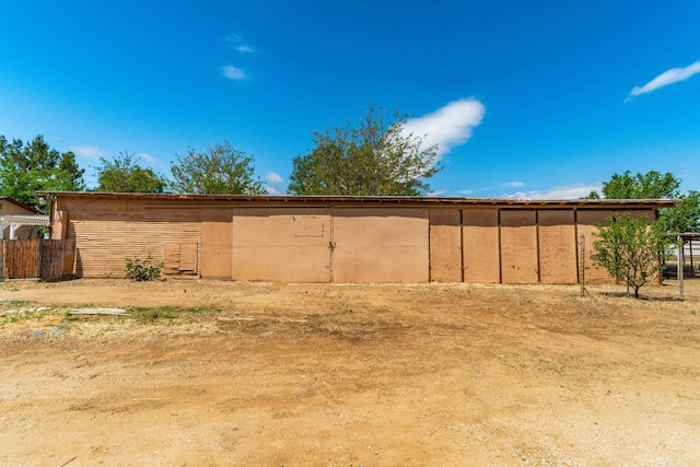 view of outdoor structure featuring fence