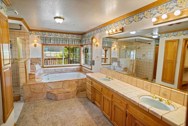 bathroom featuring a shower stall, a textured ceiling, ornamental molding, and a sink