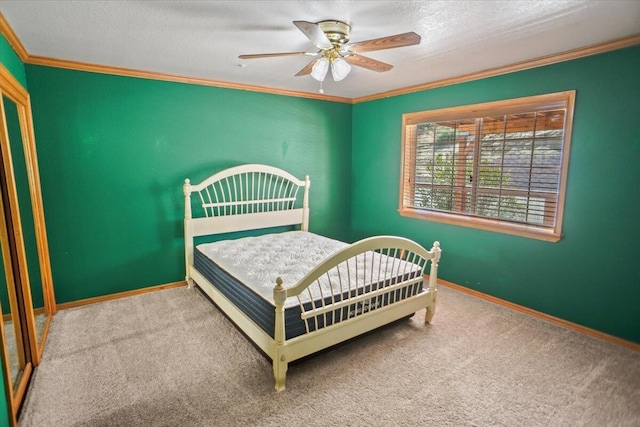 carpeted bedroom featuring crown molding, a textured ceiling, baseboards, and ceiling fan