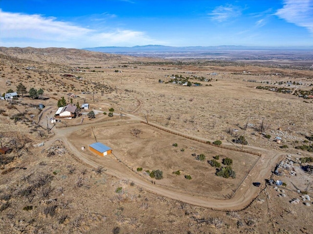 bird's eye view with a rural view, a mountain view, and view of desert