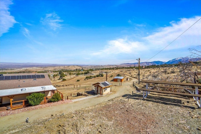 birds eye view of property with a mountain view and a rural view