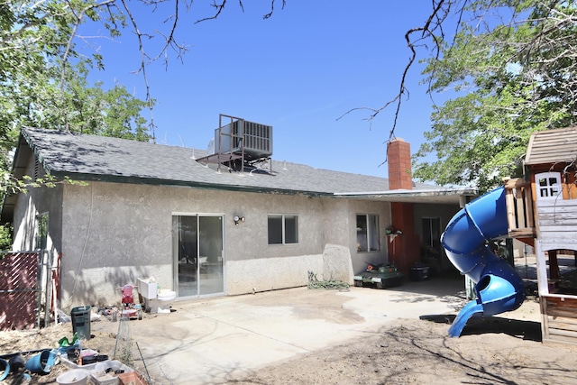 39928 E 179th St, Palmdale, CA 93591 - rear view of house with stucco siding, a playground, roof with shingles, a patio, and a chimney