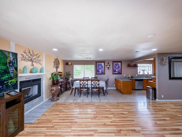 45431 Sancroft Ave, Lancaster, CA 93535 - dining room with light wood-style floors, baseboards, a fireplace with flush hearth, and recessed lighting