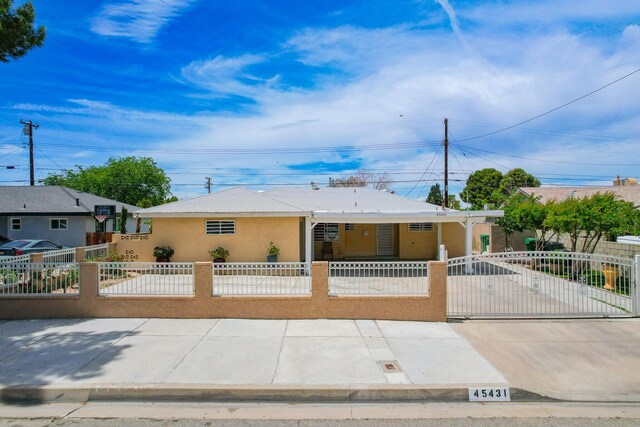 45431 Sancroft Ave, Lancaster, CA 93535 - view of front of house with a fenced front yard, stucco siding, and a gate